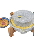 Manual Stone Grain Mill For Dry And Wet Grinding with granite stone top, wood base, and adjacent bowl of grains.