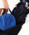 Person carrying blue bag with Set Of 3 Golf Chipping Nets With 12 Inch, 18 Inch, And 24 Inch Pop Up Targets in golf bag.