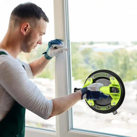 Man using DEWINNER 8-inch glass suction cup lifter on a window; lime-green and black tool