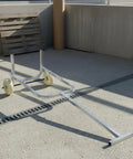 Gas Cylinder Cart Hand Truck Transporter With Tubular Steel Frame And Upright Push Design Front Control Bar Two Wheels For Warehouses, Workshops And Job Sites Heavy Duty Construction, Smooth Maneuverability, Durable And Safe. Steel gas cylinder cart with two wheels on concrete