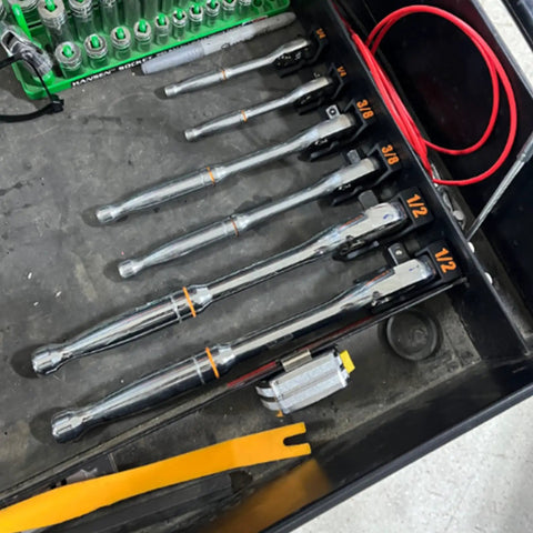 Magnetic Ratchet Holder Set For Toolbox with three modular holders for 1/4, 3/8, 1/2 inch wrenches and sockets, in a garage setup.