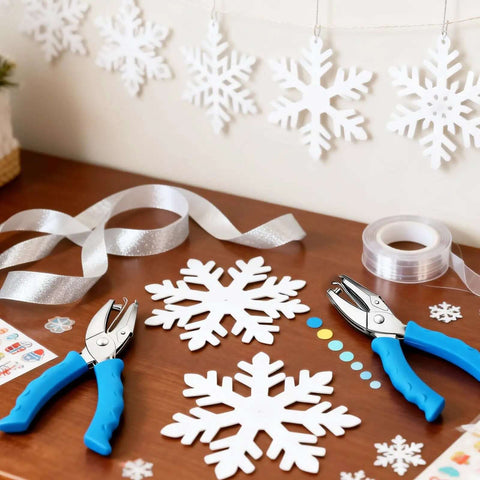Adjustable Handheld Circle Hole Punch for crafts with blue soft grip on table, surrounded by snowflake cutouts and ribbons.