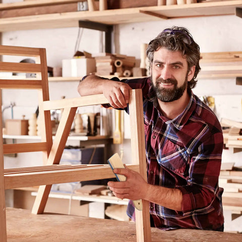Man using 2 Piece Steel File Card Brush Set 8 Inch Abrasive Hand File Cleaner on wooden furniture in workshop.