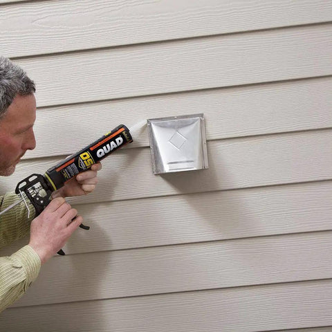 Person applying Beige Window Door And Siding Sealant 10 Oz Tubes Advanced Formula Weatherproof Exterior Caulk to siding