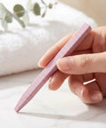 Hand holding pink stone nail file from Stone Nail File Set With Pumice Stick And Cuticle Pusher For Fingernails And Toenails Care