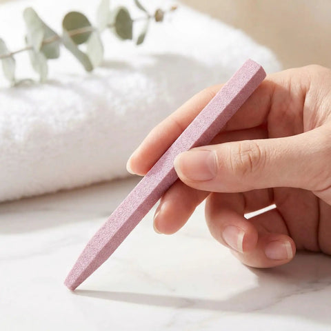 Hand holding pink stone nail file from Stone Nail File Set With Pumice Stick And Cuticle Pusher For Fingernails And Toenails Care