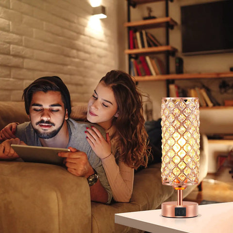 Rose Gold Crystal Table Lamp With 3 Way Dimmable Touch Control And USB C And USB A Ports on a white table in cozy living room setting.