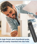 Man assembling furniture with 15 Pack 4mm By 30mm Black Oxidized Dowel Pins 304 Stainless Steel Cylindrical Shelf Pegs Chamfered Ends