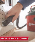 Close-up of hand using 2.5 gallon wet dry shop vac attachment, demonstrating conversion to blower function.
