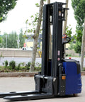 Heavy Duty Electric Pallet Stacker With Battery Powered Forklift Lift System parked outdoors, showcasing hydraulic lifting mechanism.