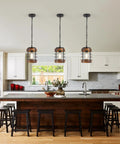Black Farmhouse Pendant Lights for Kitchen Island, 1-Light Metal Cage Rustic Wood Pendant Light Fixtures above a kitchen island.