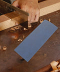 Wet And Dry Sandpaper Sheets Kit With Silicon Carbide Grit For Metal Wood Furniture Cars And Electronics 36 Pro Grade Rectangle Sanding Pads For Polishing And Finishing on a wood surface with a hand saw.