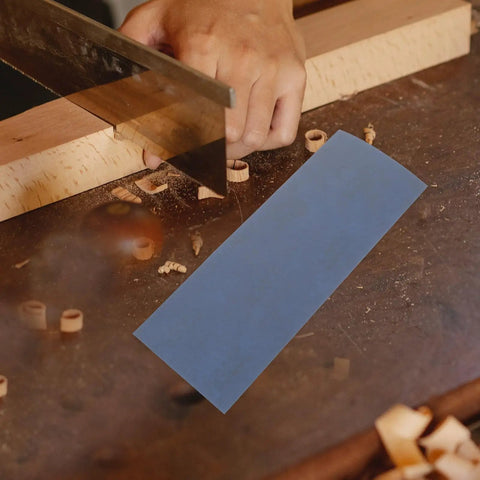 Wet And Dry Sandpaper Sheets Kit With Silicon Carbide Grit For Metal Wood Furniture Cars And Electronics 36 Pro Grade Rectangle Sanding Pads For Polishing And Finishing on a wood surface with a hand saw.