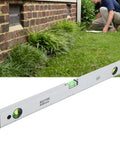Baxnore Spirit Level Strong Aluminum Alloy with Measurement, (600mm) on grass used for outdoor leveling.