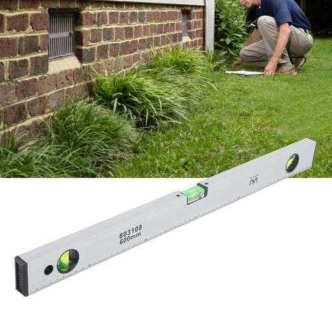 Baxnore Spirit Level Strong Aluminum Alloy with Measurement, (600mm) on grass used for outdoor leveling.