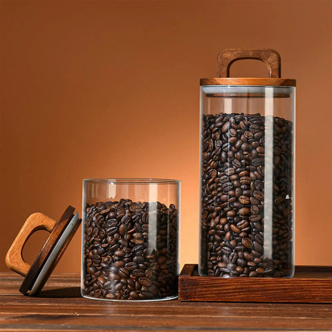Premium Glass Coffee Canister With An Airtight Wooden Lid To Keep Your Daily Grind Fresh Kitchen Counter Storage Jars filled with coffee beans.