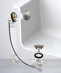 Heavy Duty Cable Driven Bath Waste Drain Assembly With Twenty Seven Long Cable And Solid Brass Handle Fits One Half Schedule Forty PVC Pipe Featuring Smooth Pop Up Stopper Valve And Tight Strainer Plate For Hassle Free Bathroom Updates, shown installed with tub.
