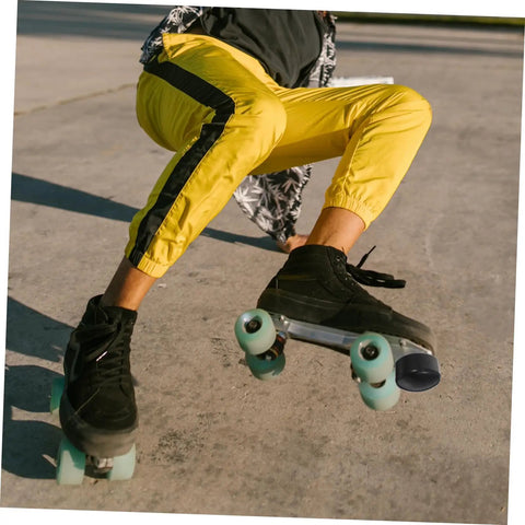 Person skating in yellow pants wearing quad roller skates with Adjustable Elastic Brake Block For Quad Roller Skates And Ice Skates Rubber Brake Stopper Kit With Easy Install Tool For Women Men Boys And Girls Universal Skating Brake System
