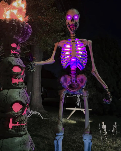 12 Foot Skeleton Light Kit With RGB Color Changing LEDs Outdoor Halloween Decor With Timer Waterproof Boss Level Giant Skeleton Accessory For A Spooky Front Yard Display Skeleton Not Included lighting up a large skeleton at night.