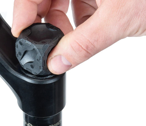 Hand using Ultimate Suspension Fork Cap Removal Tool For Fox And RockShox Top Caps With Six Sided Design on bicycle fork