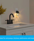 Vintage Style LED Night Light 4 Pack, Plug In Dusk To Dawn Sensor on a wall above a white bathroom countertop, black finish.