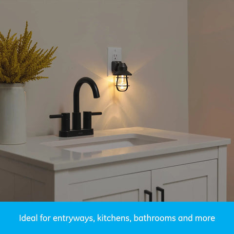 Vintage Style LED Night Light 4 Pack, Plug In Dusk To Dawn Sensor on a wall above a white bathroom countertop, black finish.