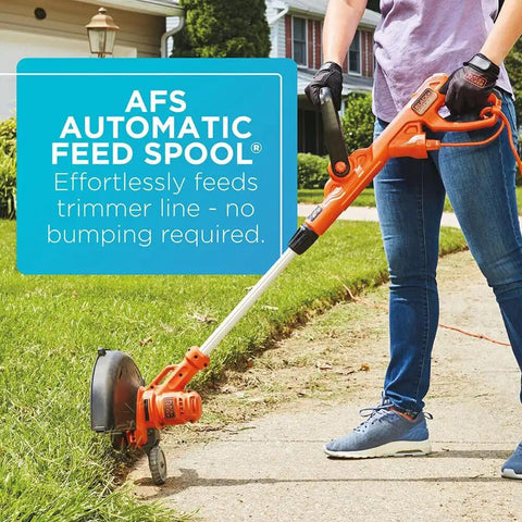 Person using 2 In 1 Weed Wacker And Edger With Wheel Guide, 14 Inch Electric Trimmer, 6.5 Amp Power, Auto Feed Spool on lawn edge.