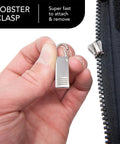 4 Pack Heavy Duty Zipper Pulls Replacement Clips Clip On Tabs Silver For Jackets Coats Luggage Suitcases Backpacks Boots And More Grab And Go Easy Install Zipper Puller Parts being attached to a zipper.