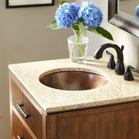 Dual Mount Handmade Pure Solid Copper Bathroom Sink In Aged Copper Finish, Fifteen And A Half Inch, with floral decor on countertop