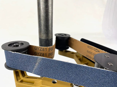 Badass Bbs-40a Pipe Polisher And Grinder Including 100 Sanding Belts Kit showing sanding belt on metal roller for pipe finishing.