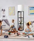 Smart RGB Shelf Floor Lamp With USB Ports And Power Outlet in a cozy playroom with children, featuring modern black design