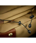 Close-up of Rucksack 25 Camera Bag For DSLR Gear With Tablet Pocket, showcasing drawstring closure and chocolate leather trim.