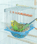 4 Pack Slick Bird Hatching Nest Bowls Featuring A Secure Barbed Wire Partition, green budgie in a blue nesting bowl.