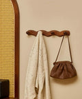 Walnut Wood Coat Rack Wall Mount Set Of 4 Heavy Duty Hooks with robe and bag hanging, modern rustic wall hanger for entryway.