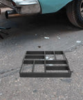 Plastic Path Maker Mold For Concrete Pavers 16.45 Inch shown on asphalt near car, ideal for DIY garden path installation.