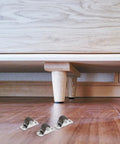 Eight Pack Heavy Duty Silent Rubber Replacement Casters With Mounting Screws For Rolling Cart Furniture Drawers Cabinets And Workbenches Top Shelf Build For Zero Hassle Gliding under a wooden cabinet.