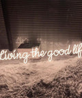 Living The Good Life LED Neon Sign Custom Personalized Home Wall Decor Large 30 Inch Indoor Light in warm white on fluffy rug