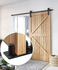 Image showing Barn Door Floor Guide Set Black Powder Coated Carbon Steel Construction With Durable POM Nylon Rollers on installed sliding door.