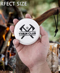 Person holding Dual Grit Axe Sharpener Stone 400 1000 for hatchets and axes with leather sheath, multipurpose sharpening puck.
