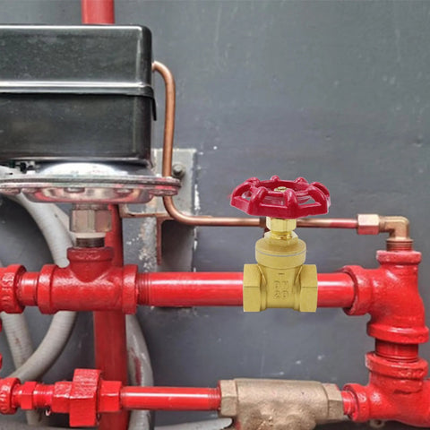 Brass 3/4-inch valve with red handwheel on red piping, DN20 female threaded ends