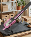 Digital Vernier Caliper 150mm Nylon Body Metric Inch displayed on a countertop measuring 180mm with a pink casing.