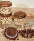 Four Piece Glass Storage Jars With Airtight Wooden Lids Wide Mouth Canister Set for storing coffee beans and grains.