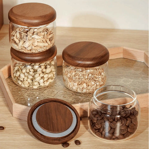Four Piece Glass Storage Jars With Airtight Wooden Lids Wide Mouth Canister Set for storing coffee beans and grains.