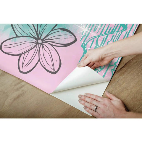 Hands peeling Under The Sea Blue Peel And Stick Wall Mural For Kids Rooms By RoomMates showing adhesive back