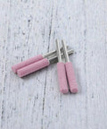 Diamond Chainsaw Sharpener Kit 32 Pieces Pink Sharpeners With 0.22 Inch Heads shown on wooden surface