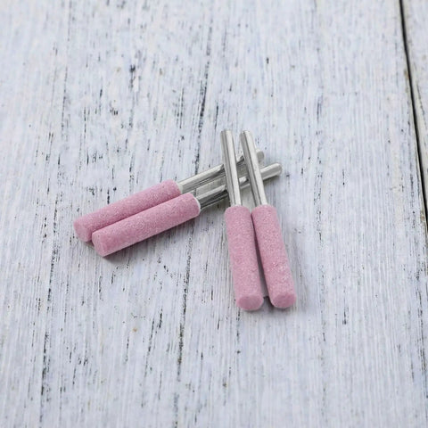 Diamond Chainsaw Sharpener Kit 32 Pieces Pink Sharpeners With 0.22 Inch Heads shown on wooden surface