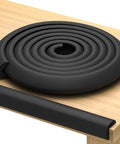 No Sweat Heavy Duty Edge Protector For Baby Proofing Main Home With Grip Tight 3M Tape And Waterproof Non Toxic Foam Padding For Sharp Furniture Corners Rugged Toddler Safe Wall Edge Wrap In Rich Black on a table.