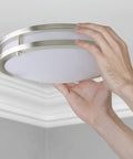 Hands installing Bright As Day LED Flush Mount Ceiling Light 10 Inch Dimmable 1350lm 5000K Daylight Brushed Nickel Round Fixture