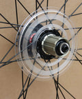 Clear Plastic Spoke Protector For Mountain Bike Rear Wheel Freewheel Flywheel Guard Easy Install Shield shown on wheel hub.