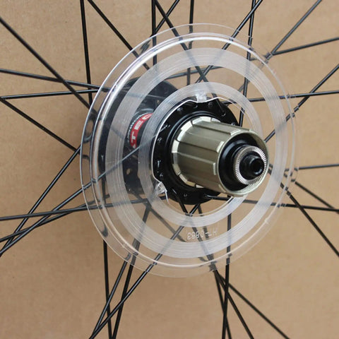 Clear Plastic Spoke Protector For Mountain Bike Rear Wheel Freewheel Flywheel Guard Easy Install Shield shown on wheel hub.
